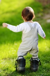 toddler walking on grass